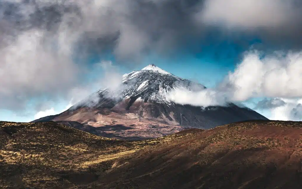 Photo by Marek Piwnicki brown and white mountain under blue sky during daytime