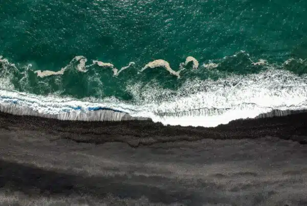 aerial photography of waves crashing on cliff at daytime